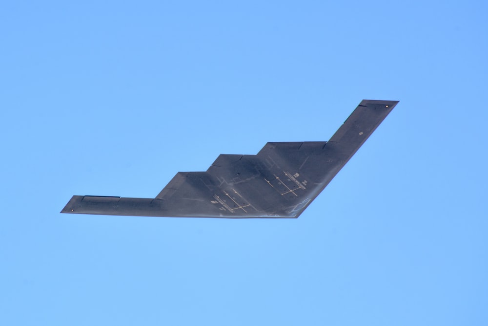 black plane under blue sky during daytime