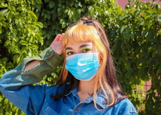 girl in blue denim jacket with blue face paint