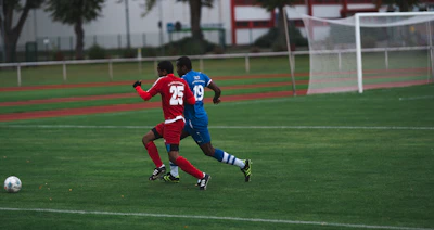 man in red and blue football jersey shirt