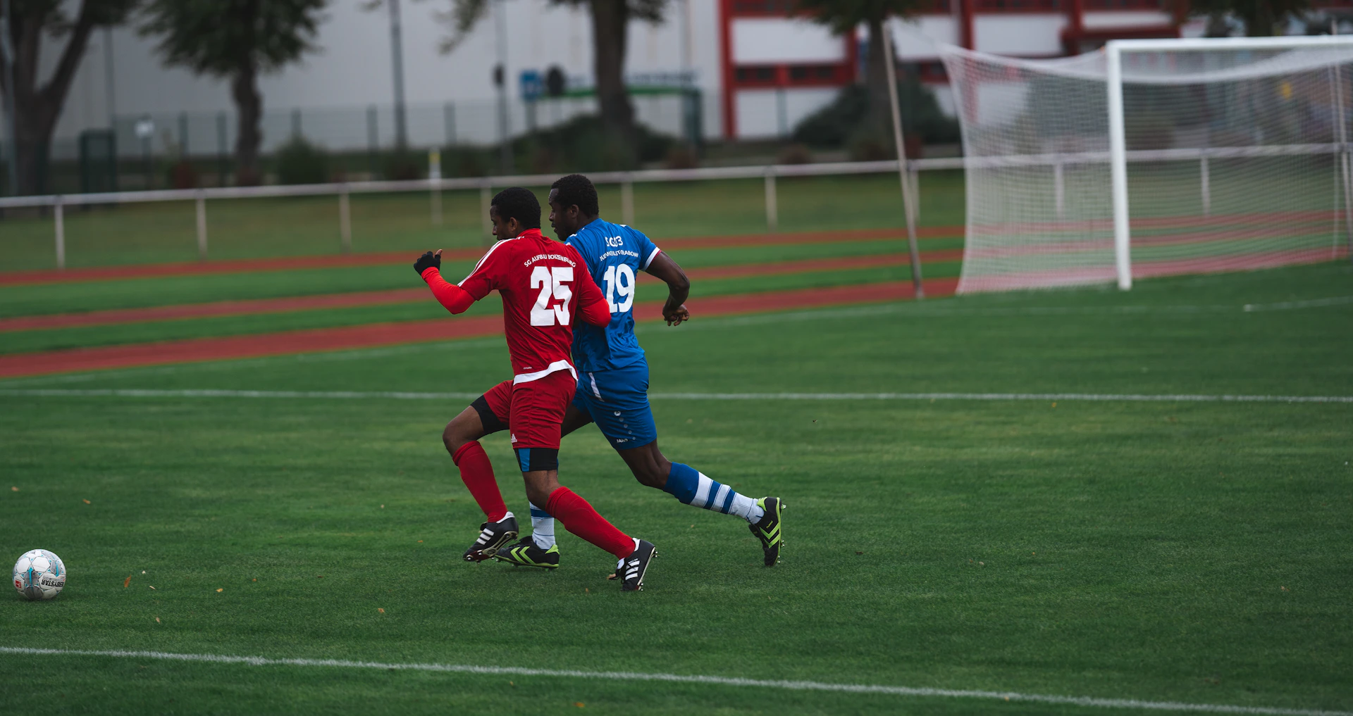 man in red and blue football jersey shirt