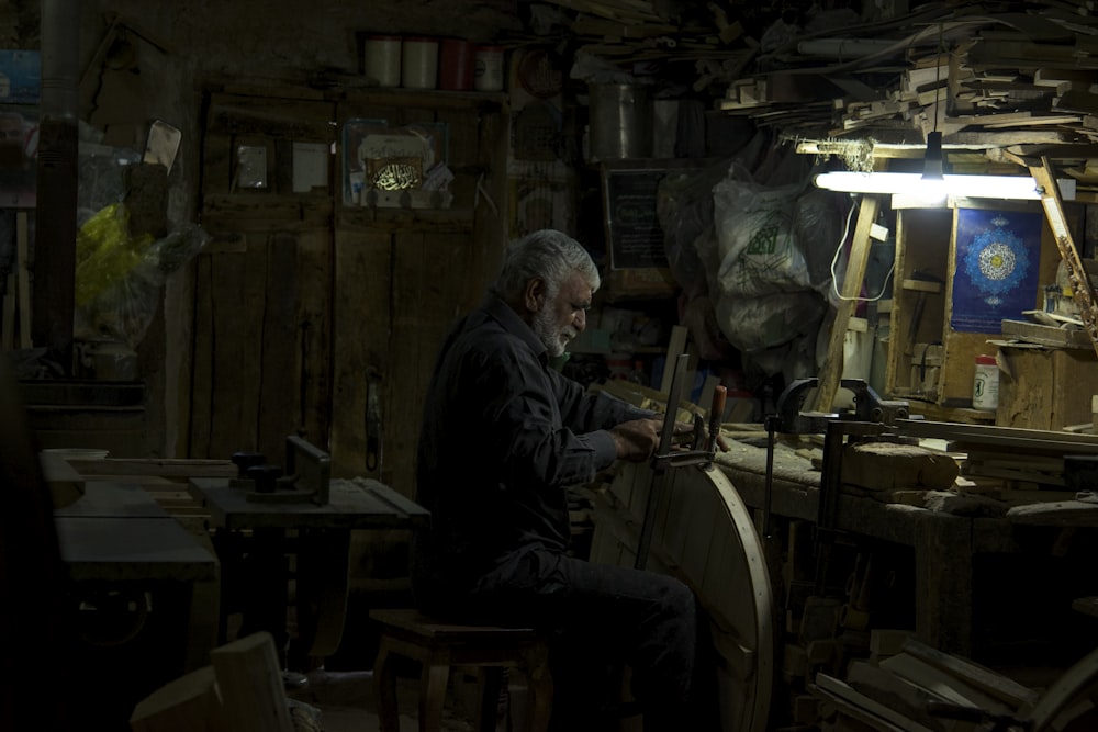 man in black jacket sitting on chair