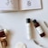 A serene flat lay of skincare products on a soft pink background, featuring creams, serums, and a delicate flower.