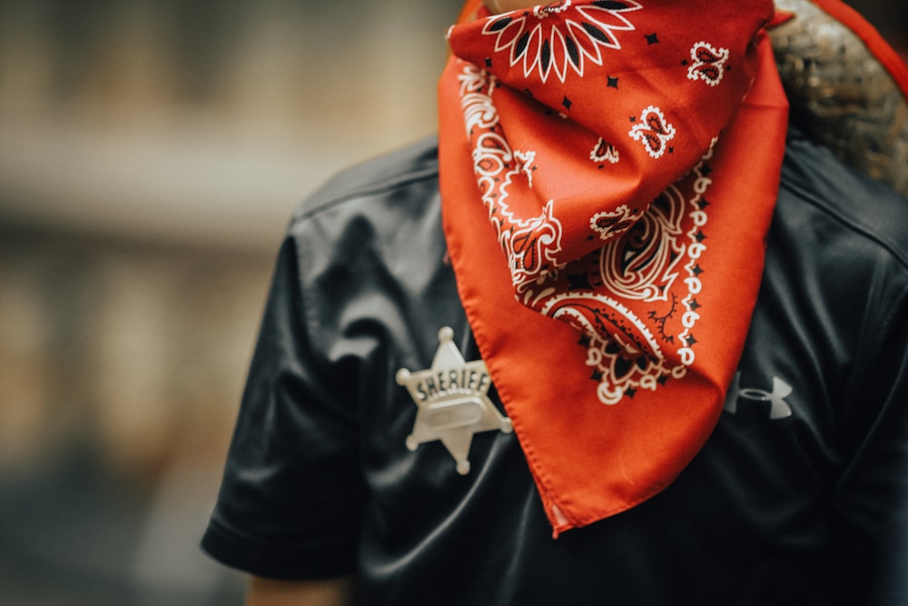 person in red and white floral scarf