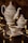 A beautifully crafted set of porcelain teaware consisting of a teapot, a sugar bowl, and a teacup with a saucer. The set features delicate floral patterns. Warm fairy lights are artistically arranged around the teaware, adding a cozy and enchanting atmosphere.