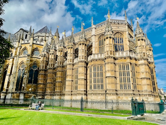 brown concrete building under cloudy sky during daytime in Westminster Abbey United Kingdom