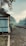 A person stands on a platform near a railway track, surrounded by lush greenery and trees. The building next to them has a ladder leaning against it, and the ground is paved with stones. The atmosphere is misty with a bluish tint, suggesting an early morning setting.
