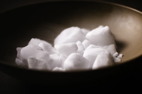 white sugar cubes in black bowl