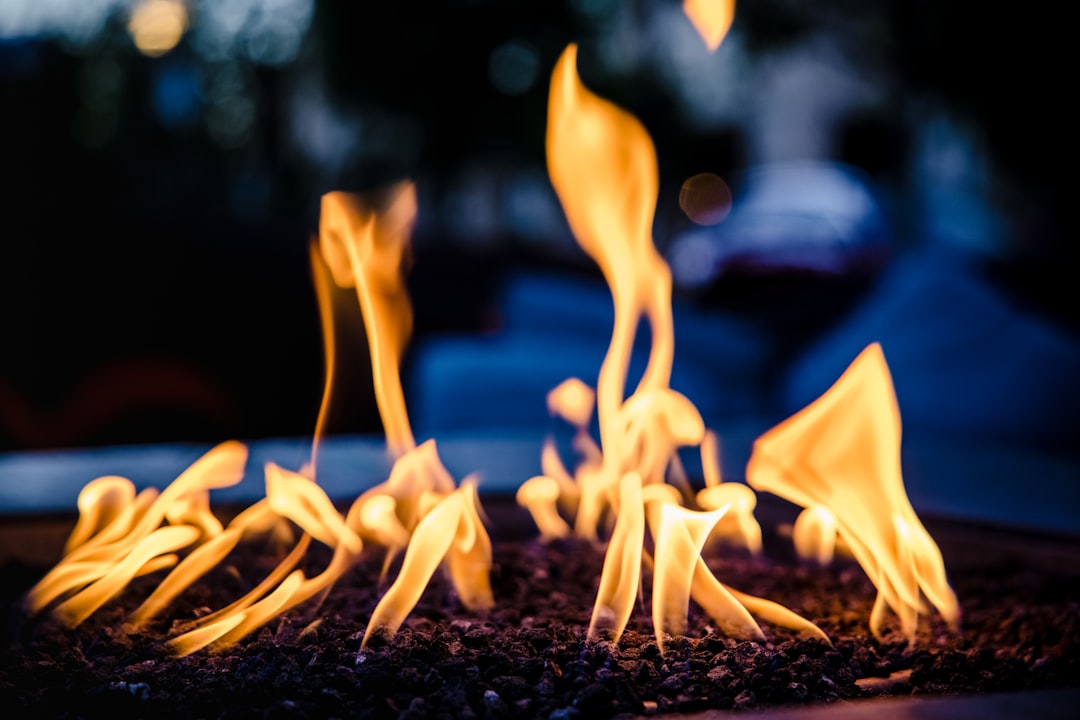 white fire on black soil during night time