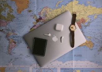 black ipad beside silver round analog watch