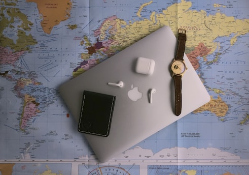 black ipad beside silver round analog watch