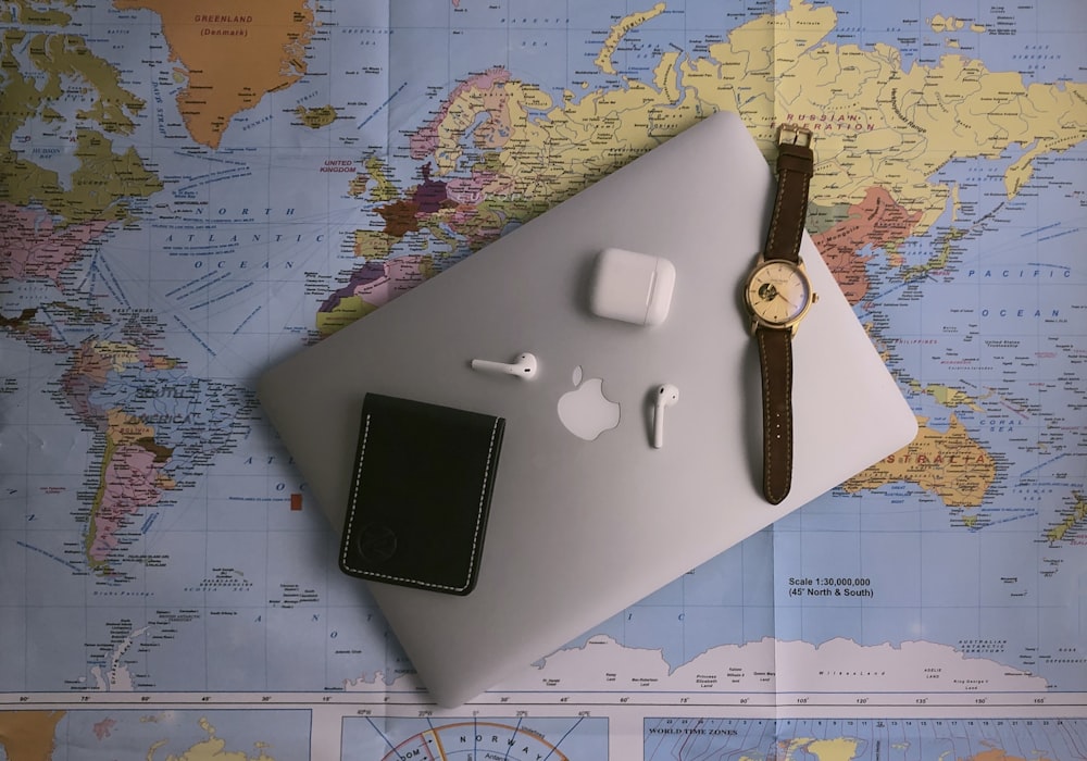 black ipad beside silver round analog watch