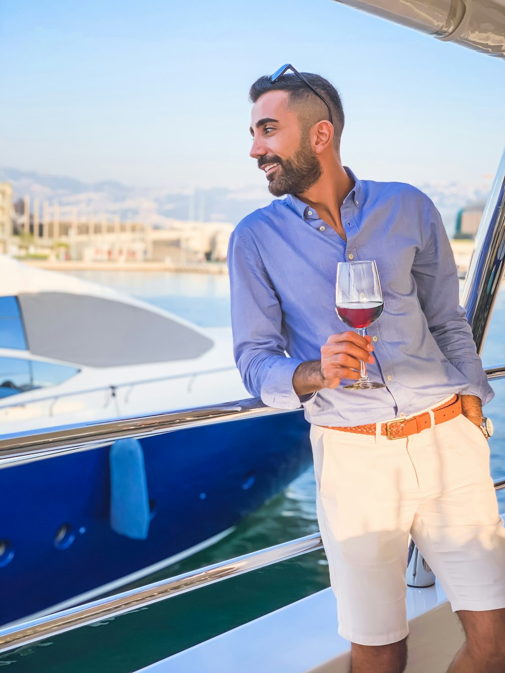 man in gray dress shirt holding clear wine glass