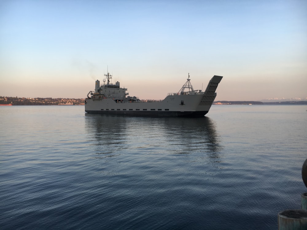 white ship on sea under blue sky during daytime