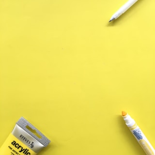 white and blue box beside white click pen