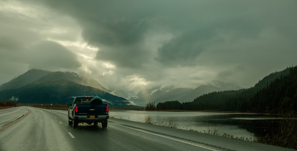 black suv on snow covered road during daytime