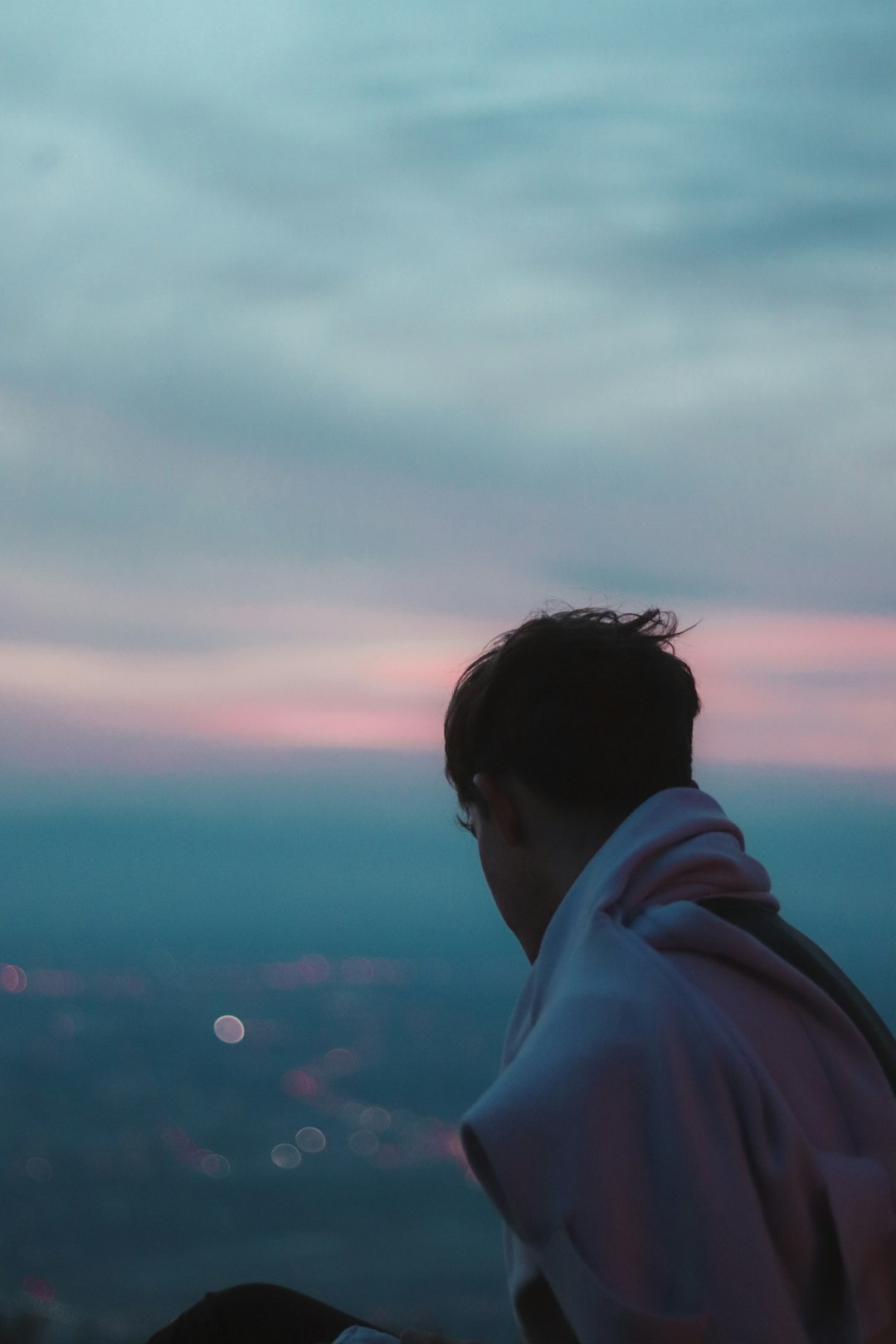 man in white hoodie looking at the sky during daytime