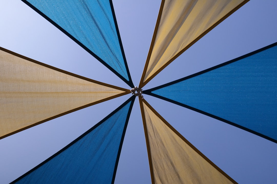 yellow and blue umbrella under blue sky