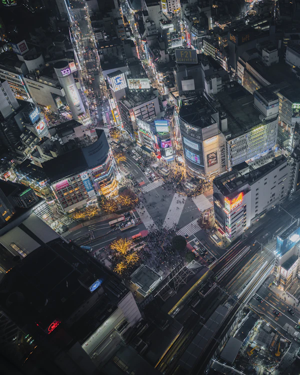Elevated night view of Shibuya Crossing in Tokyo.