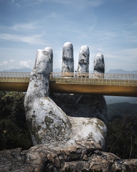 gray rock formation under white clouds during daytime