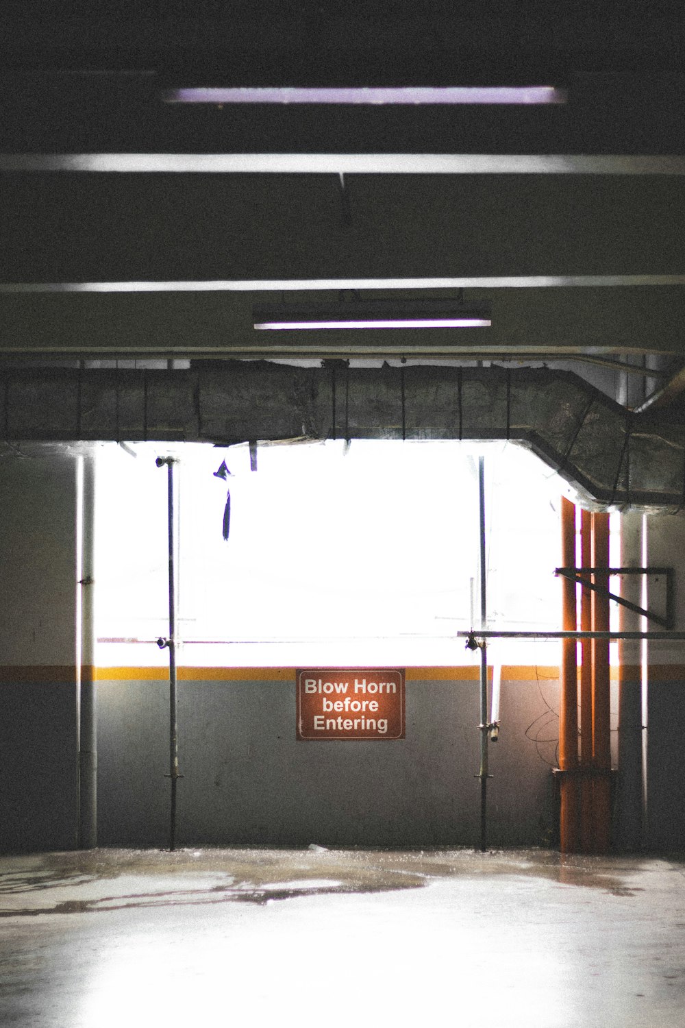 an empty parking garage with a sign on the wall