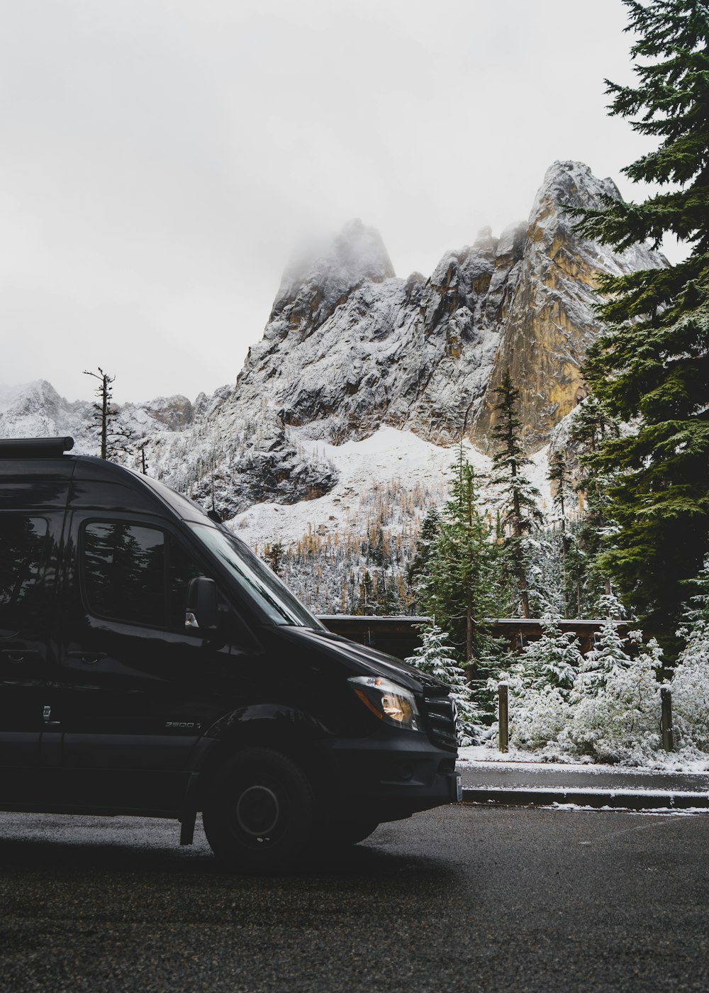 black suv on road near snow covered mountain during daytime