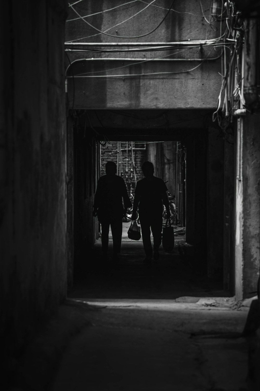 silhouette of man and woman walking on hallway