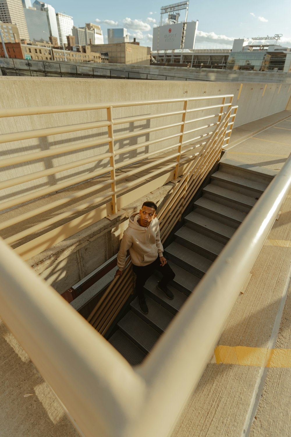 woman in white long sleeve shirt and black skirt standing on gray metal staircase