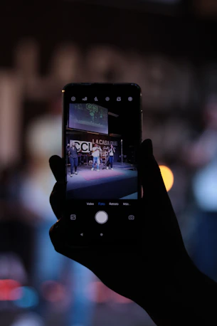 person holding black iphone 4