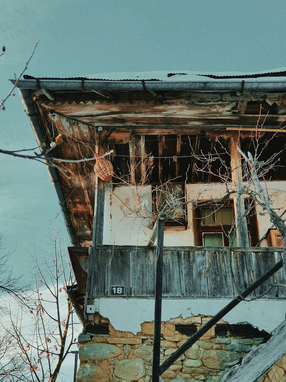 white and brown wooden house near body of water during daytime