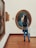 A man admiring a striking portrait in a gallery setting.