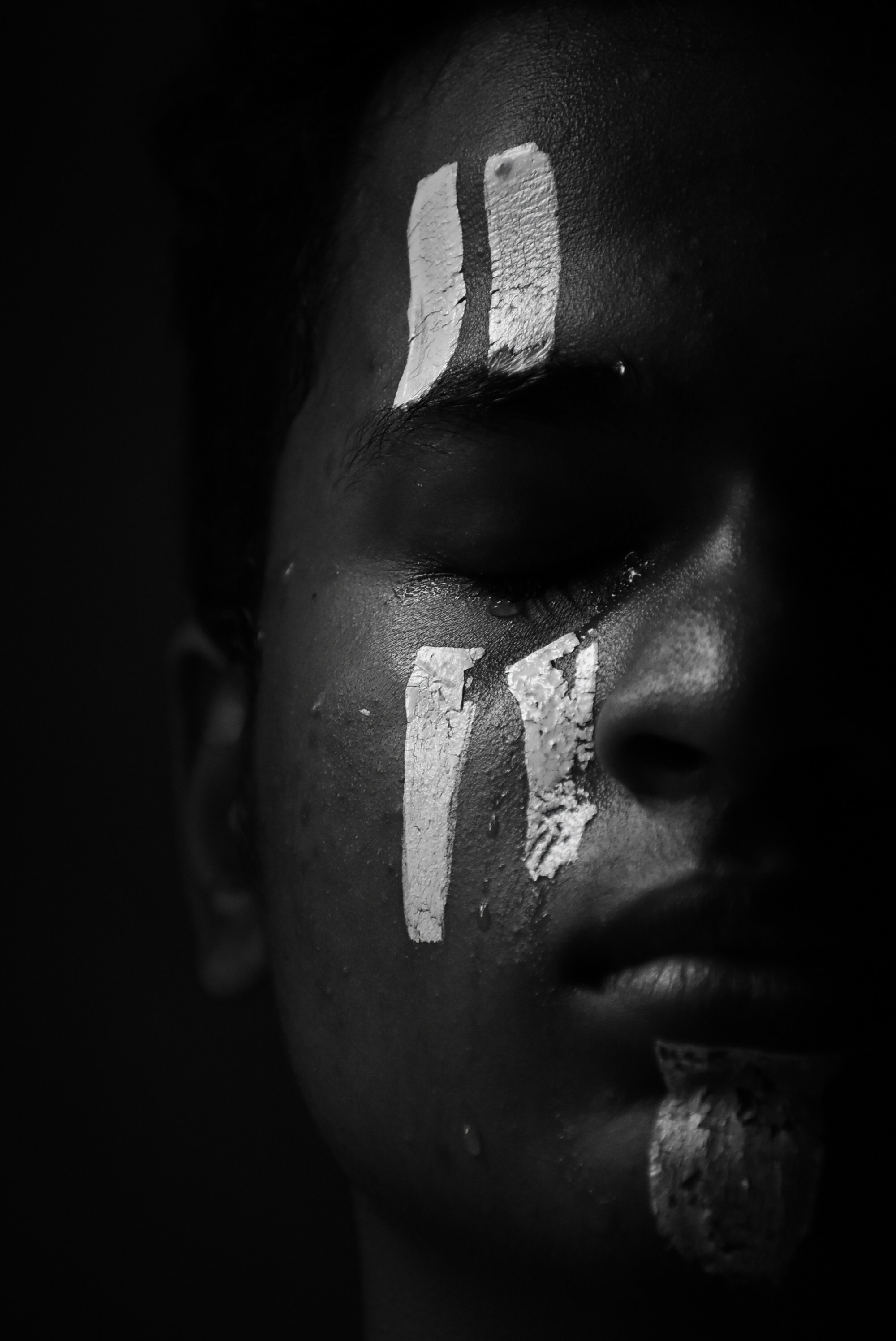 grayscale photo of person with white powder on face