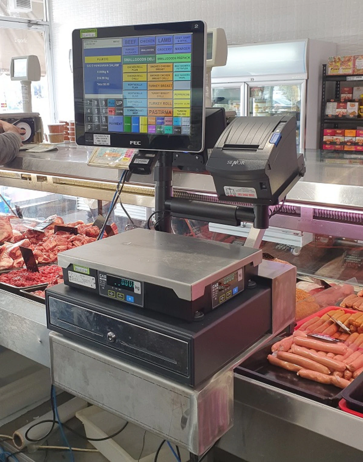 Commercial scale and POS equipment at a butcher and deli counter