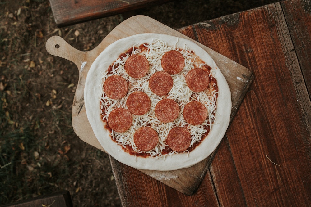 red and white pizza on brown wooden table