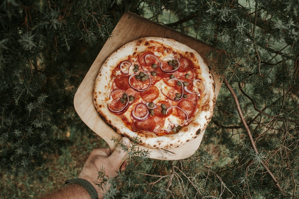 pizza on brown wooden tray