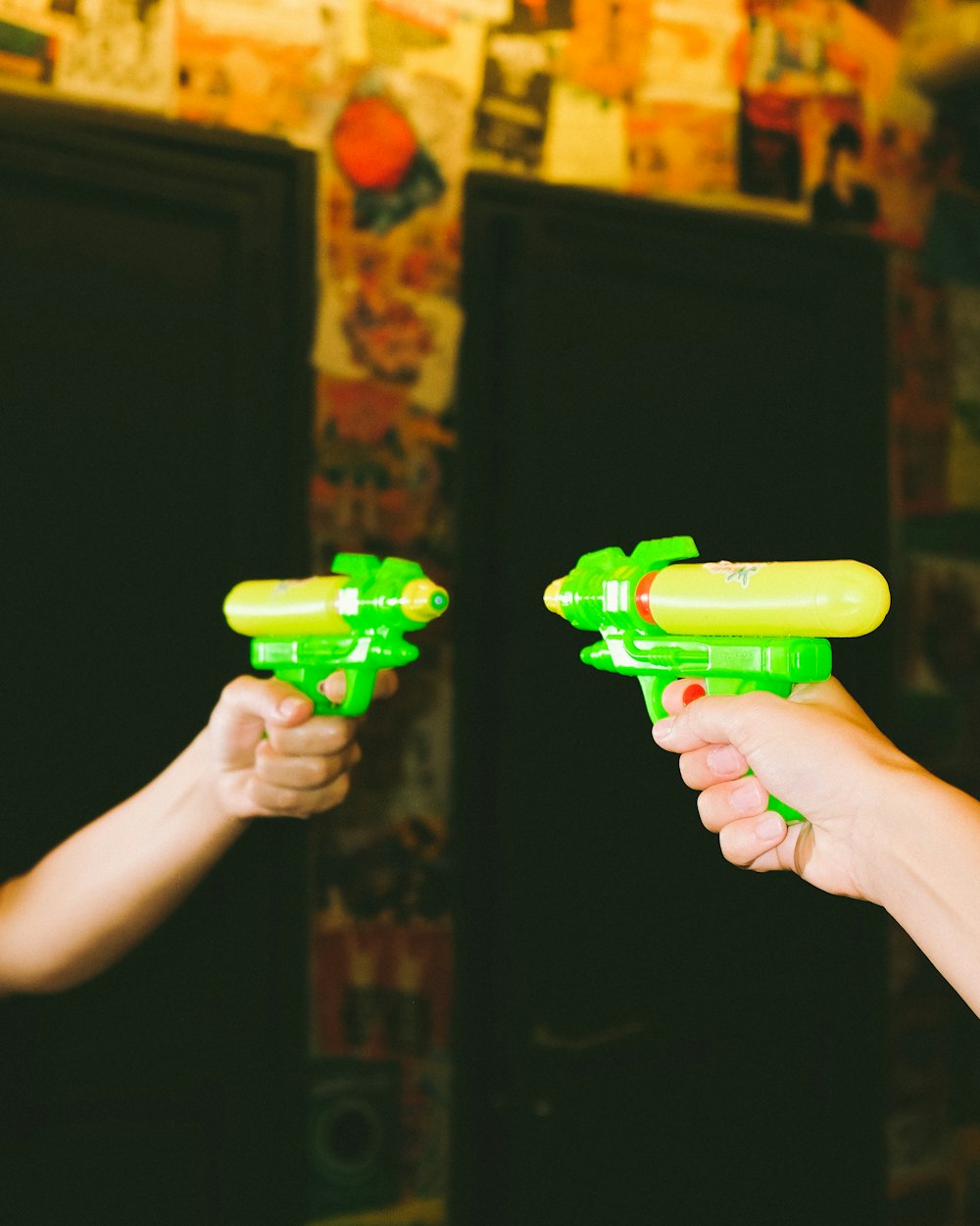 person holding green plastic toy