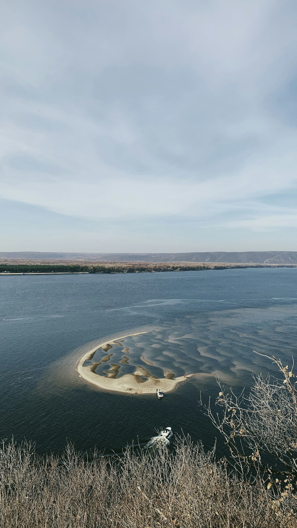 body of water under cloudy sky during daytime