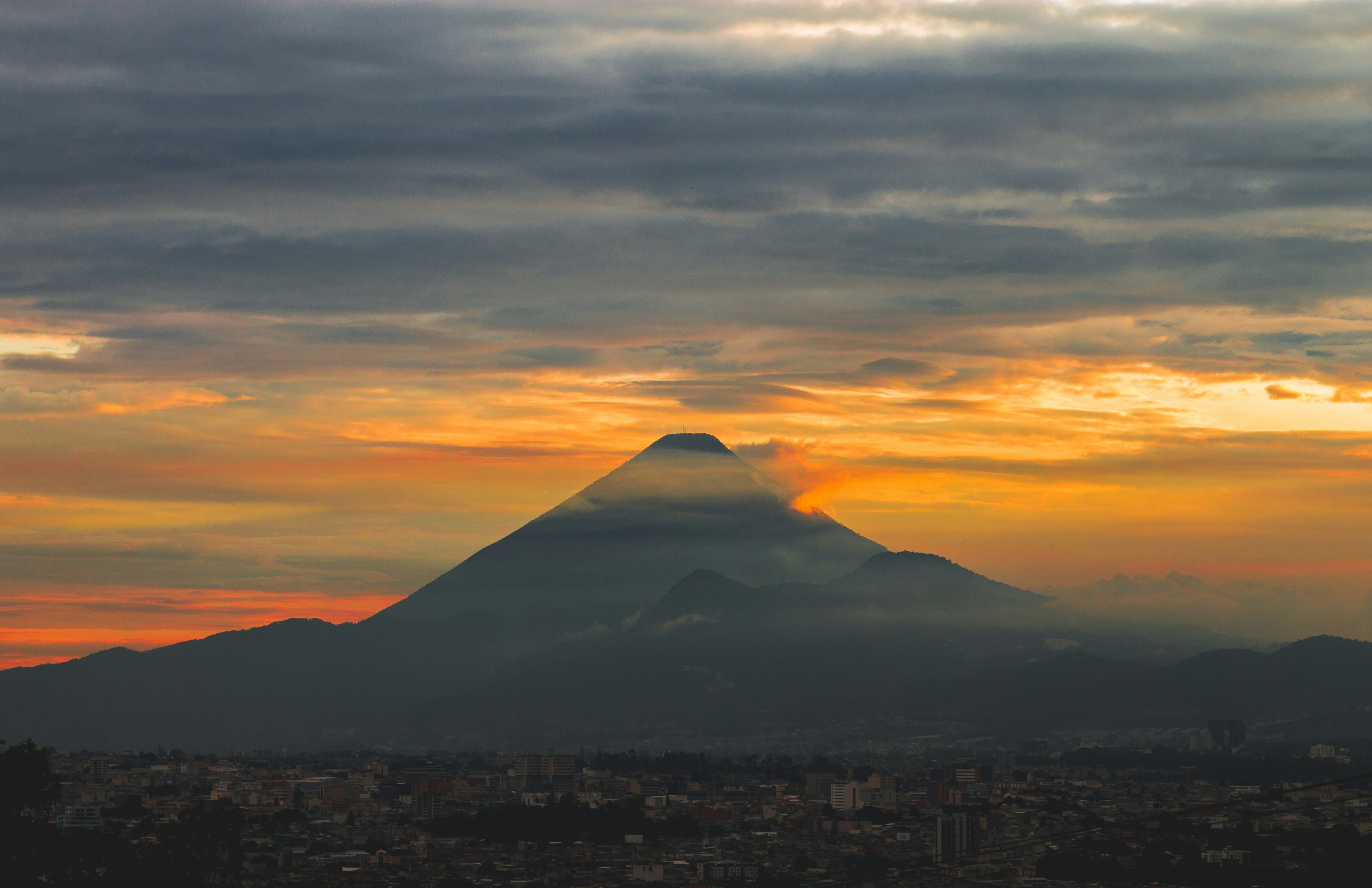 brown mountain under cloudy sky during daytime