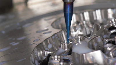Detail shot of a CNC machine precisely milling an aluminum part.