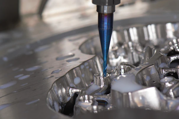 Close-up of a precision CNC machine shaping a metal automotive part.