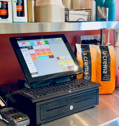 black laptop computer on brown wooden table