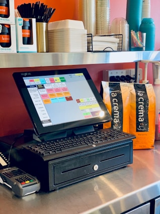 black laptop computer on brown wooden table