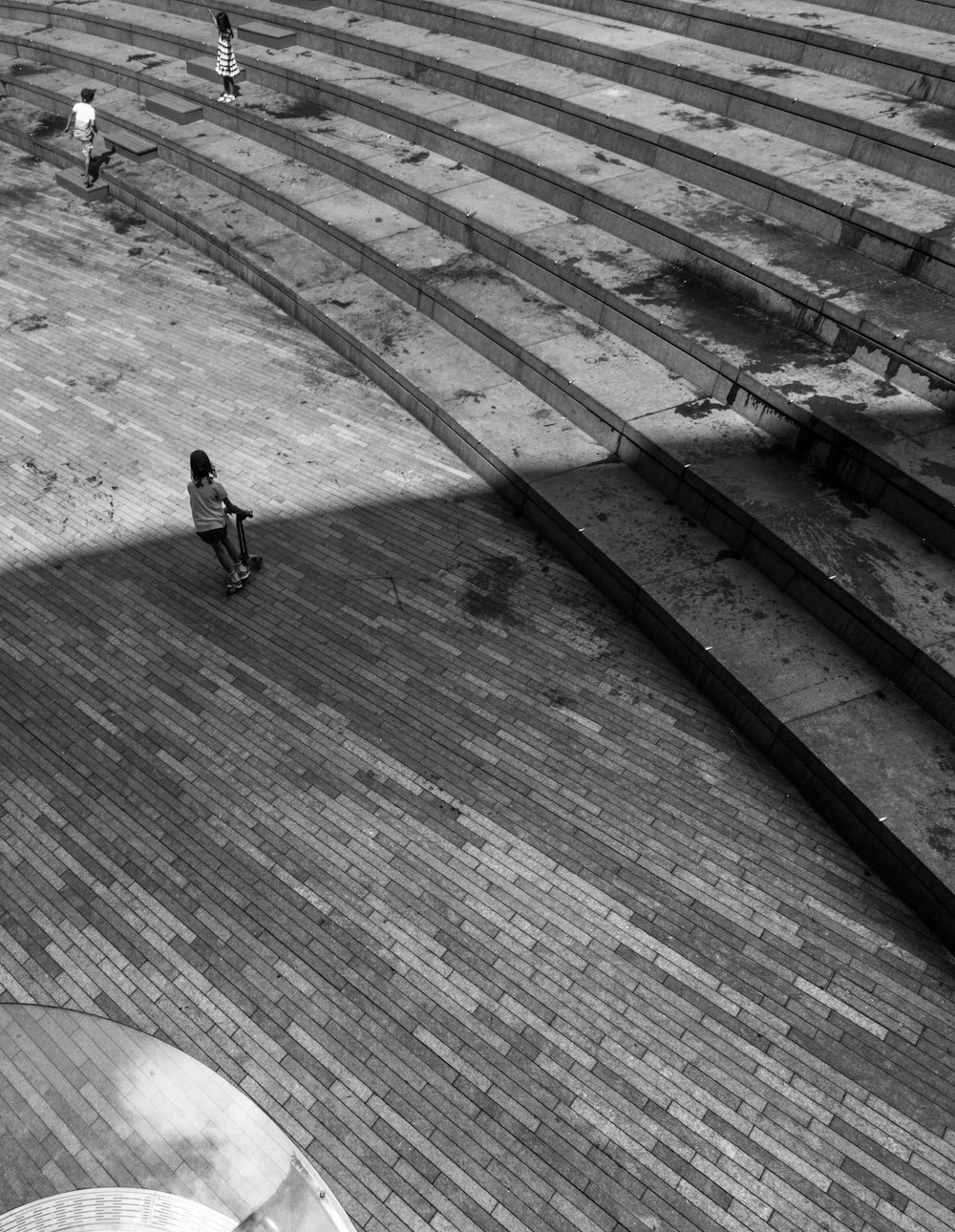 grayscale photo of person walking on concrete stairs