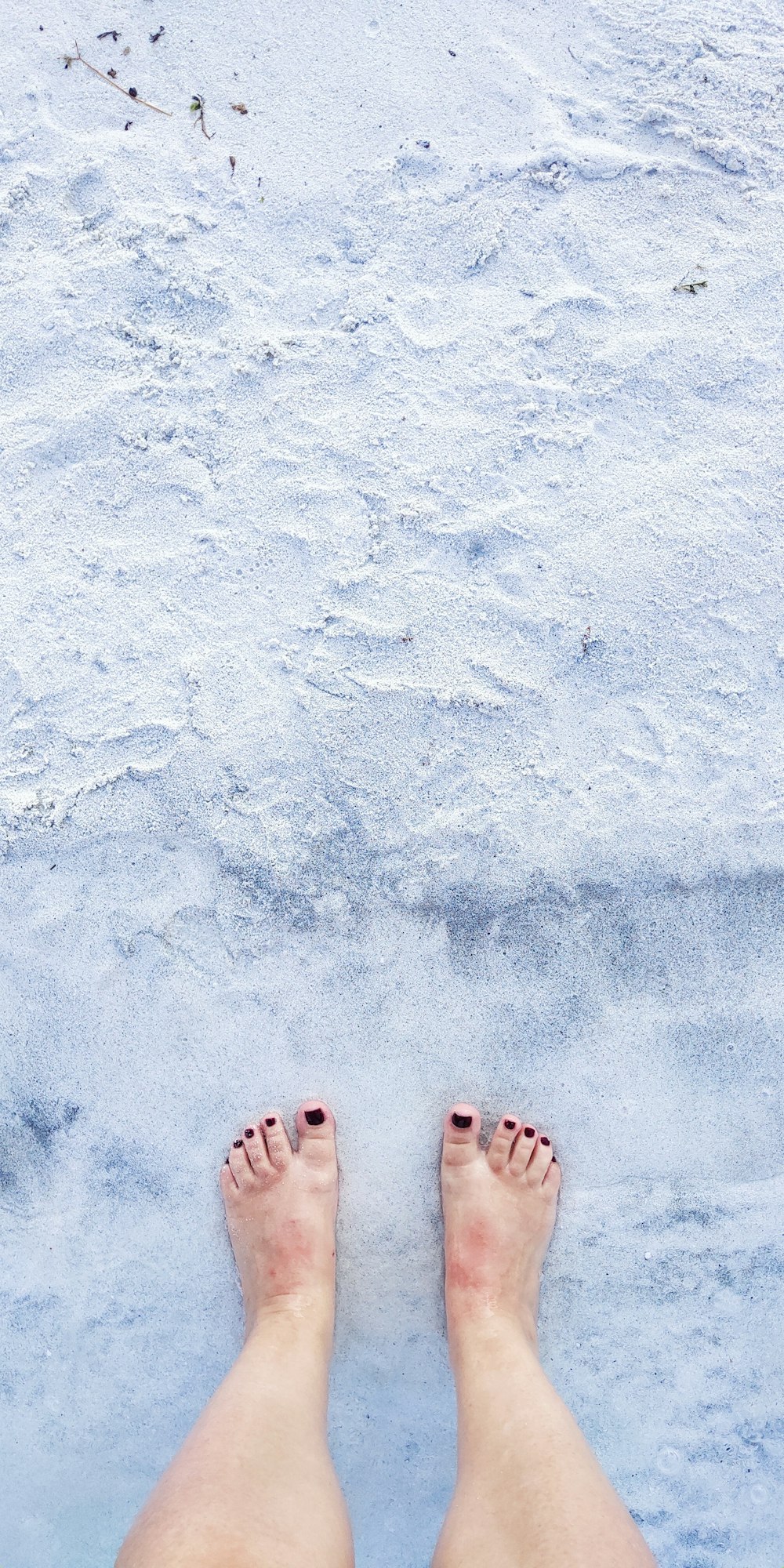 person standing on white sand