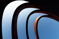 a view of a blue sky through a set of curved windows