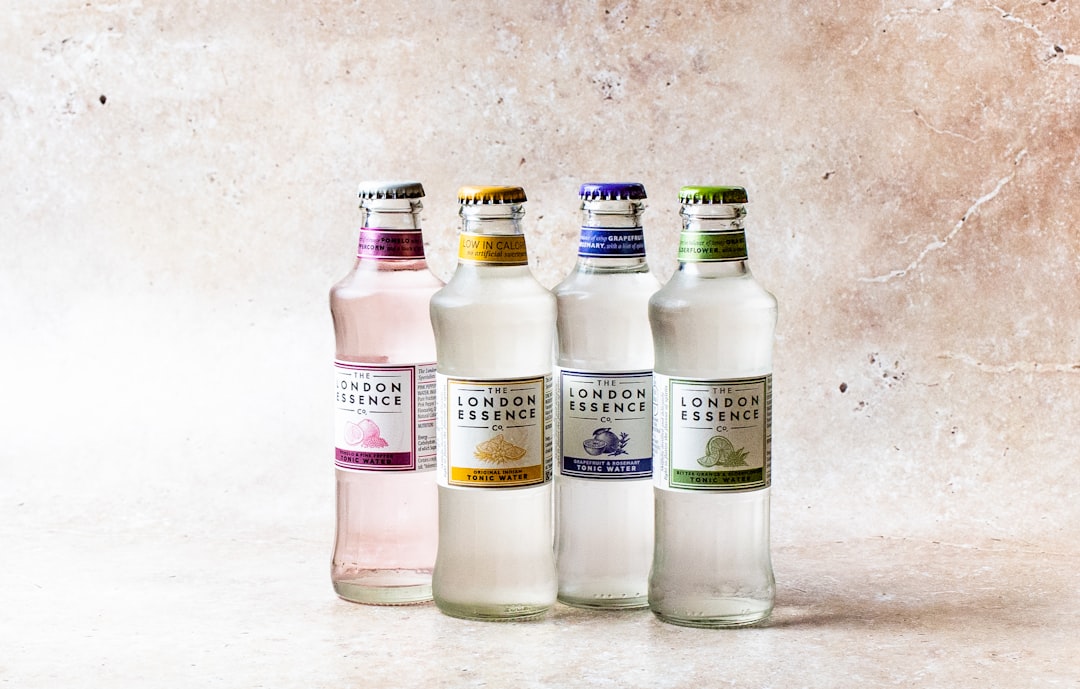 three clear glass bottles on white table