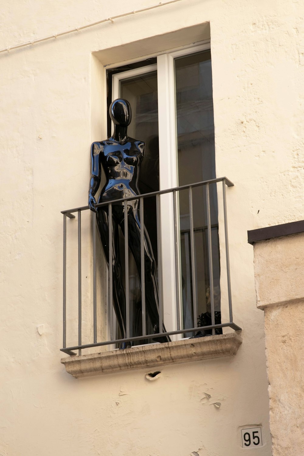 blue and black robot statue on window