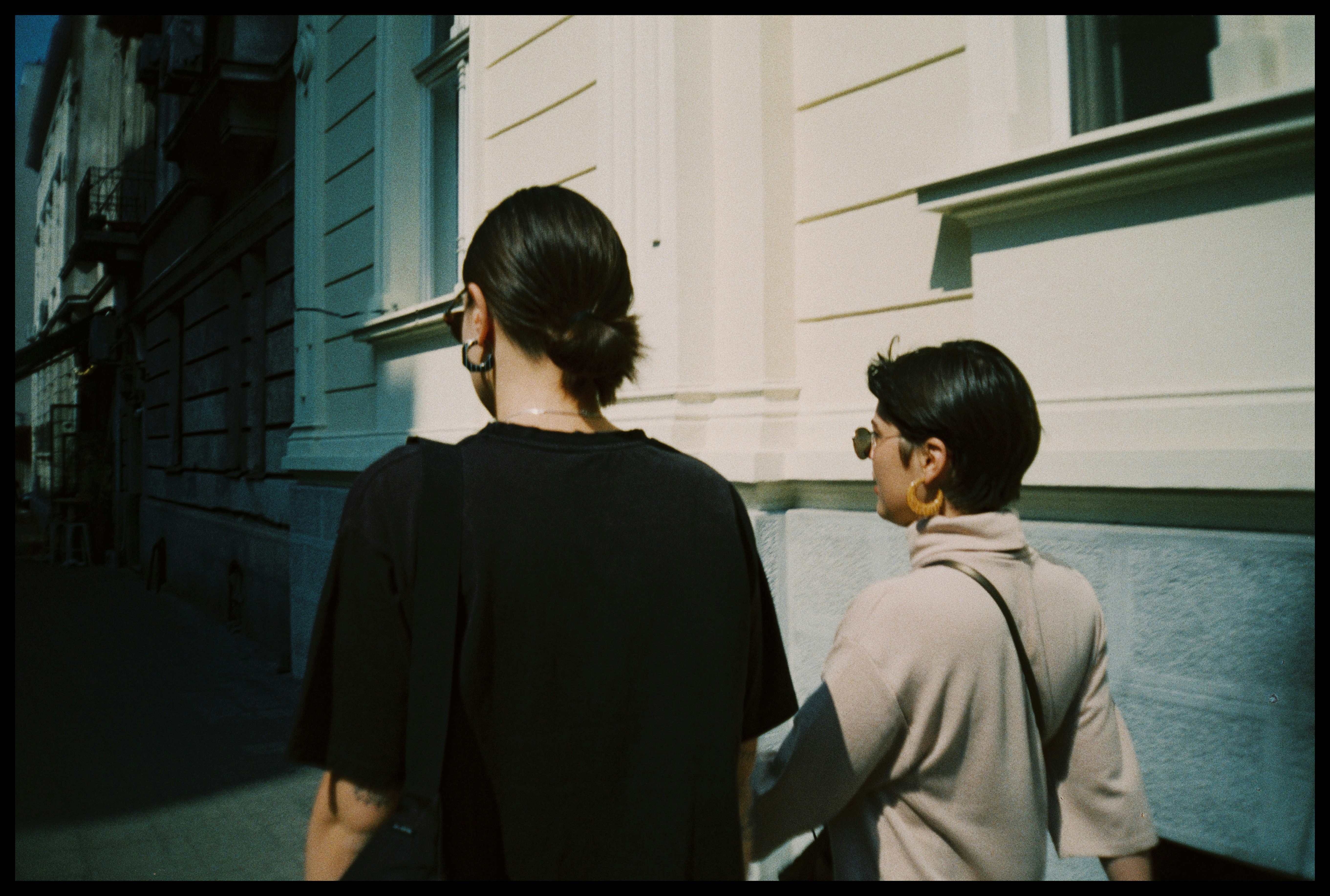 woman in black shirt standing beside man in gray coat