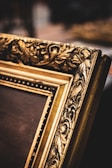 brown wooden picture frame on white textile