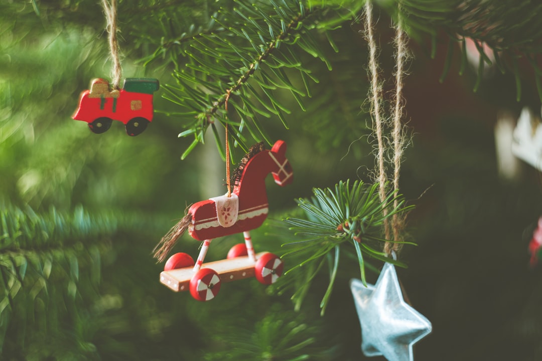 red and white plastic toy on green pine tree