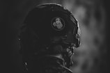 grayscale photo of man wearing helmet
